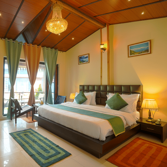 A room with wooden ceilings and a chandelier, a king bed with pillows with tablelamps of either side, etc